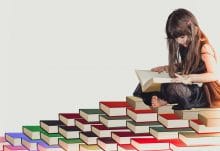 child reading a book at her kids book club