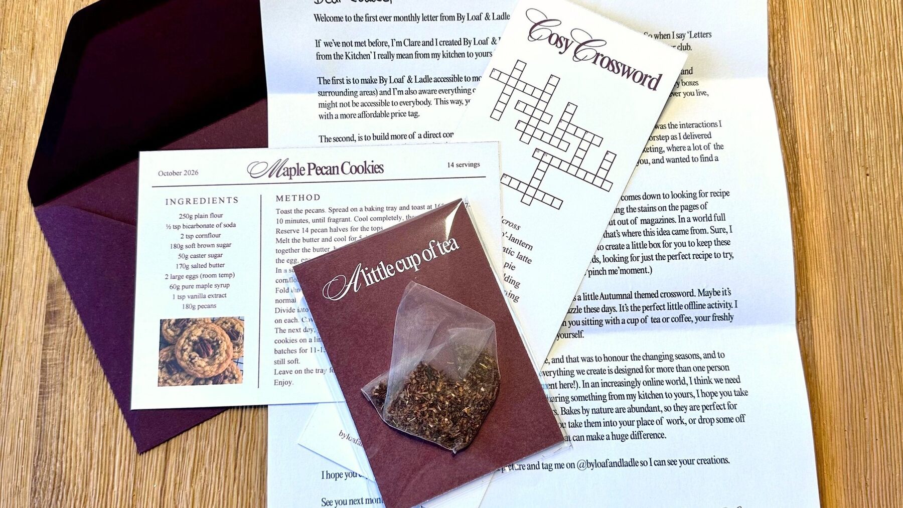 The October letter, Maple Pecan Cookies recipe card, Cosy Crossword and tea bag from A Letter from the Kitchen on a wooden table