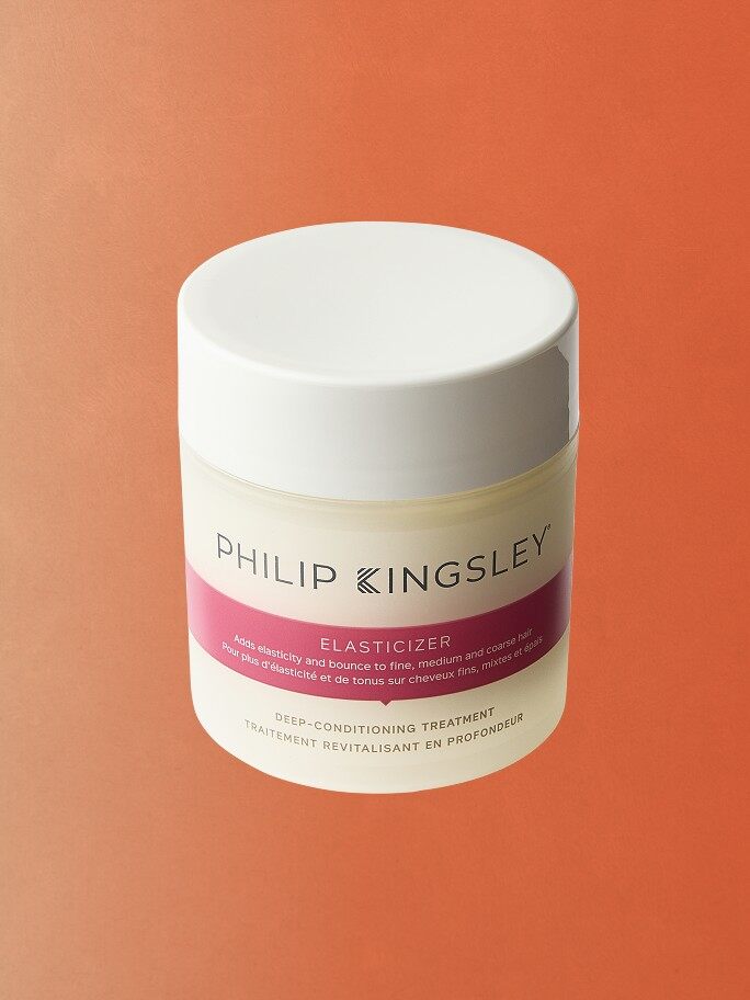 A tub of Philip Kingsley Elasticizer on an orange background