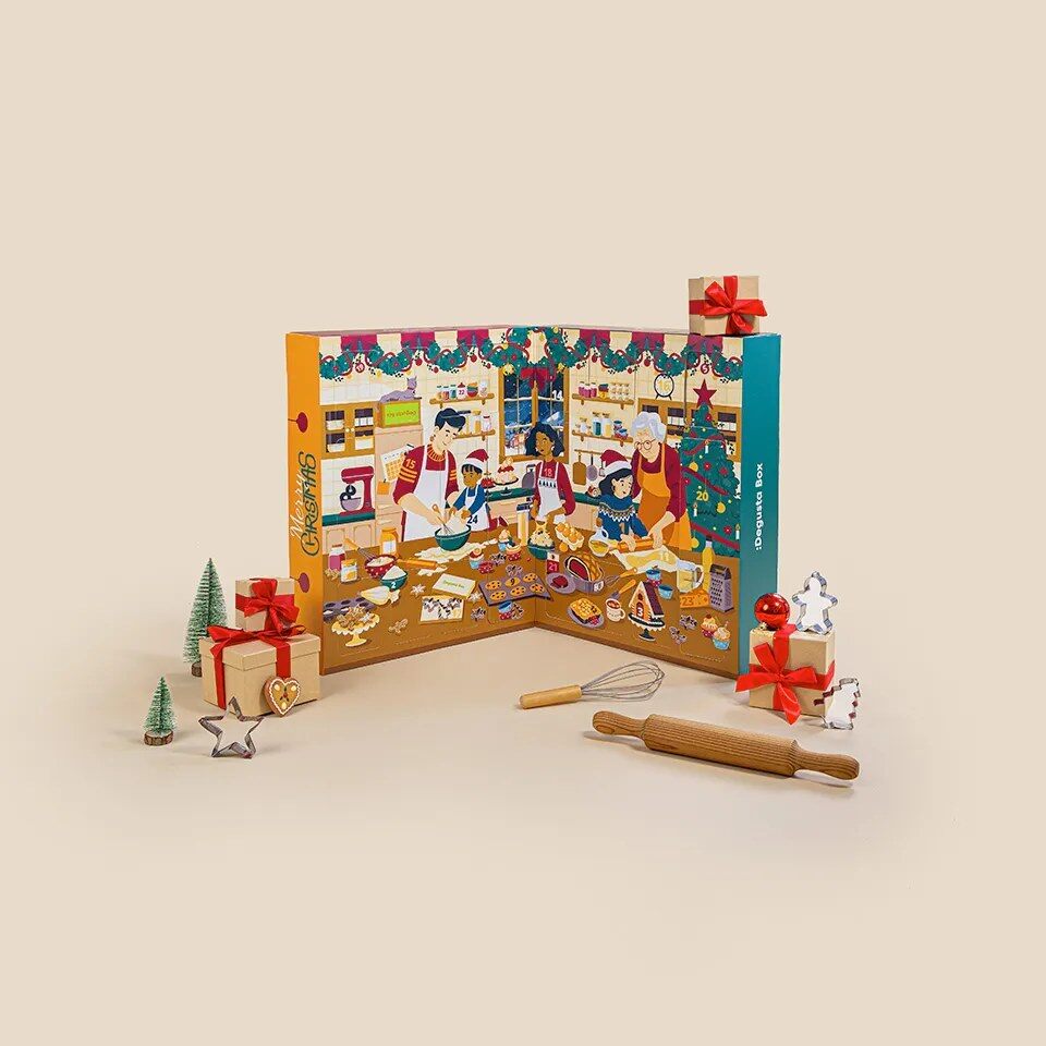 The Degustabox Cook and Bake advent calendar 2026 with a kitchen scene illustration, a rolling pin and festive props