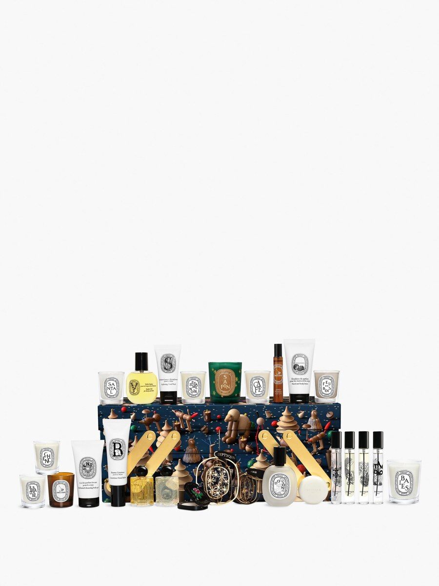 The Diptyque advent calendar 2026 contents laid out, including candles, perfume bottles, body care and a decoration set