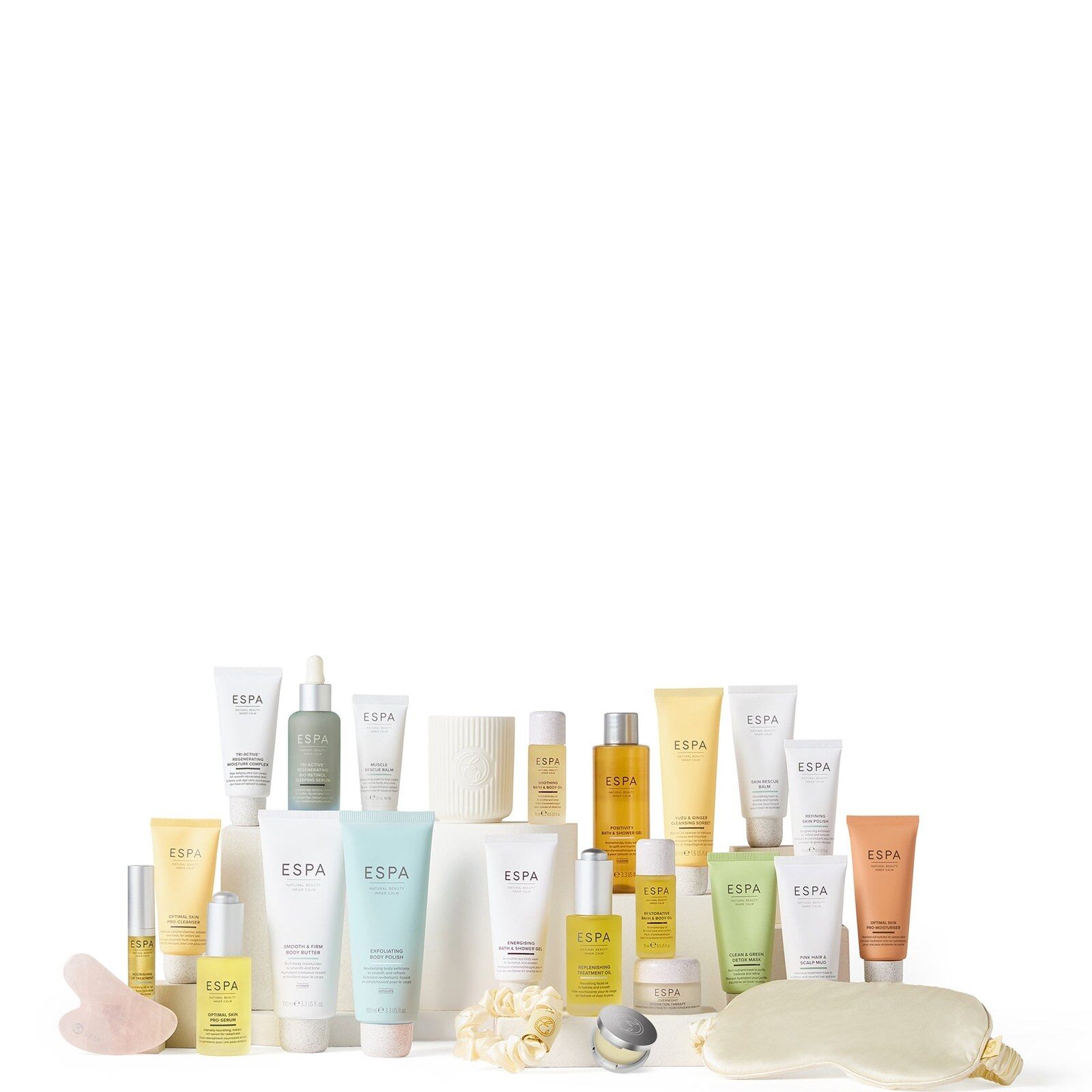 The full contents of the ESPA advent calendar lined up on a white background, from bottles and tubes to the candle and gua sha
