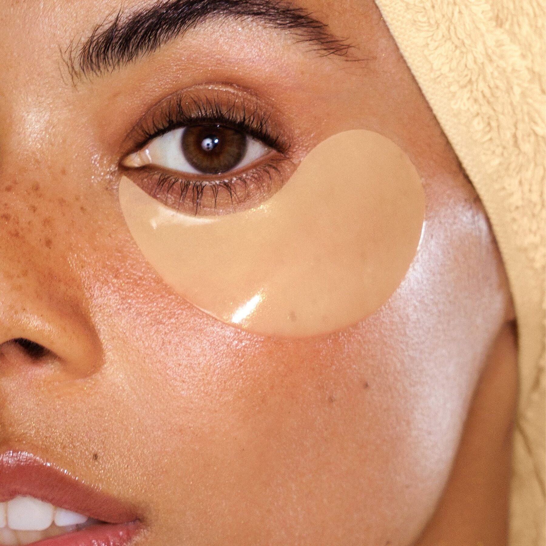 A woman with a large clear hydrogel patch under one eye