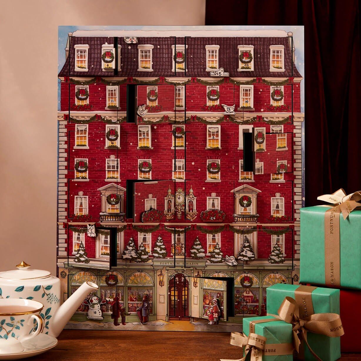 A red Fortnum and Mason advent calendar shaped like a building with many small doors