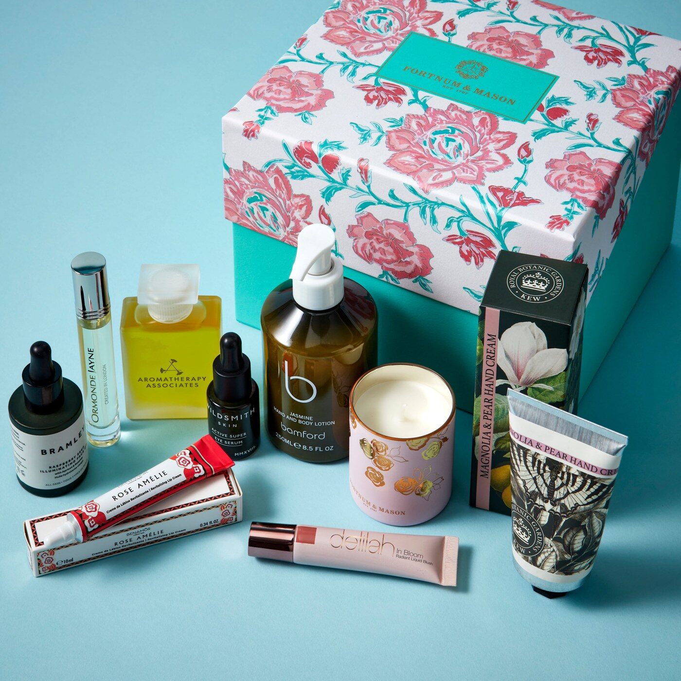 The nine products of Fortnum's Beauty Box 2026 arranged in front of the rose print box