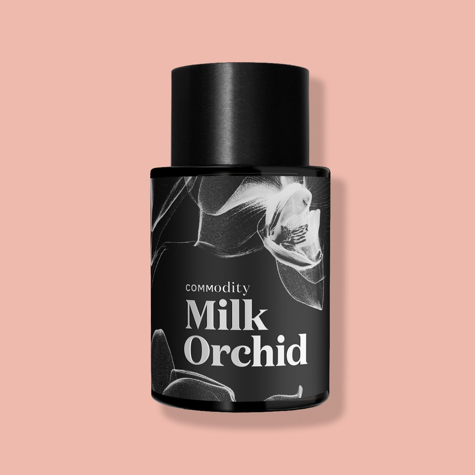 A black bottle of Commodity Milk Orchid fragrance on a pink background