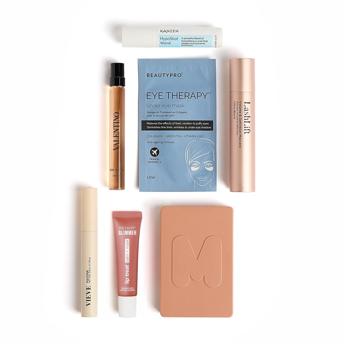 The GLOSSYBOX Christmas Cracker 2026 products laid out on a white background, including a mascara, a lip mask, a face trio and an eye mask