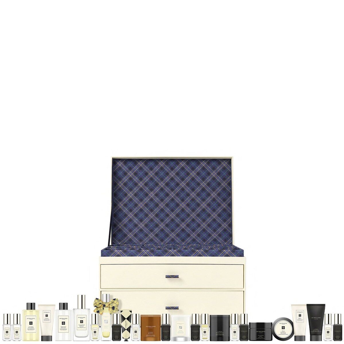 The closed Jo Malone London Christmas Kist advent calendar 2026, a cream trunk with a tartan lid, with its colognes and candles lined up in front