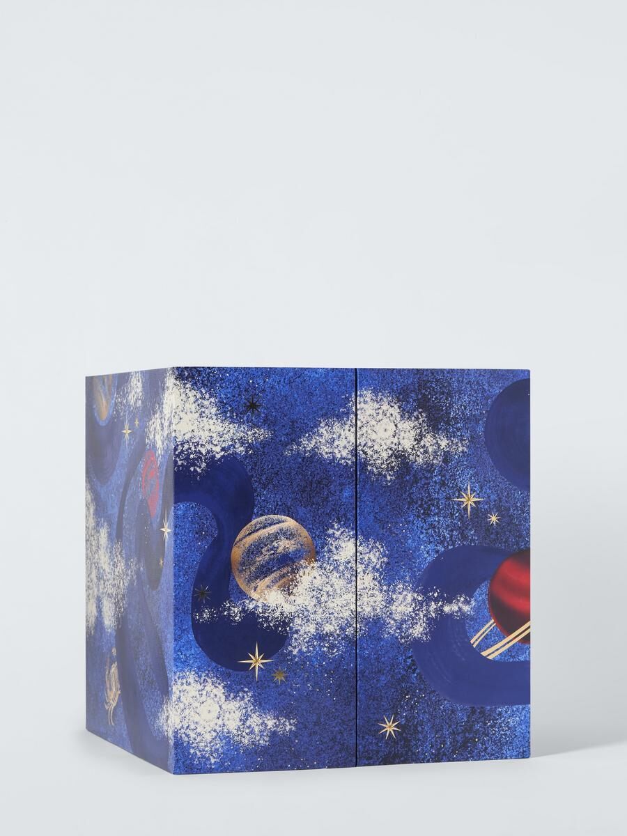 The closed John Lewis beauty advent calendar 2026, a navy box with a cosmic gold pattern