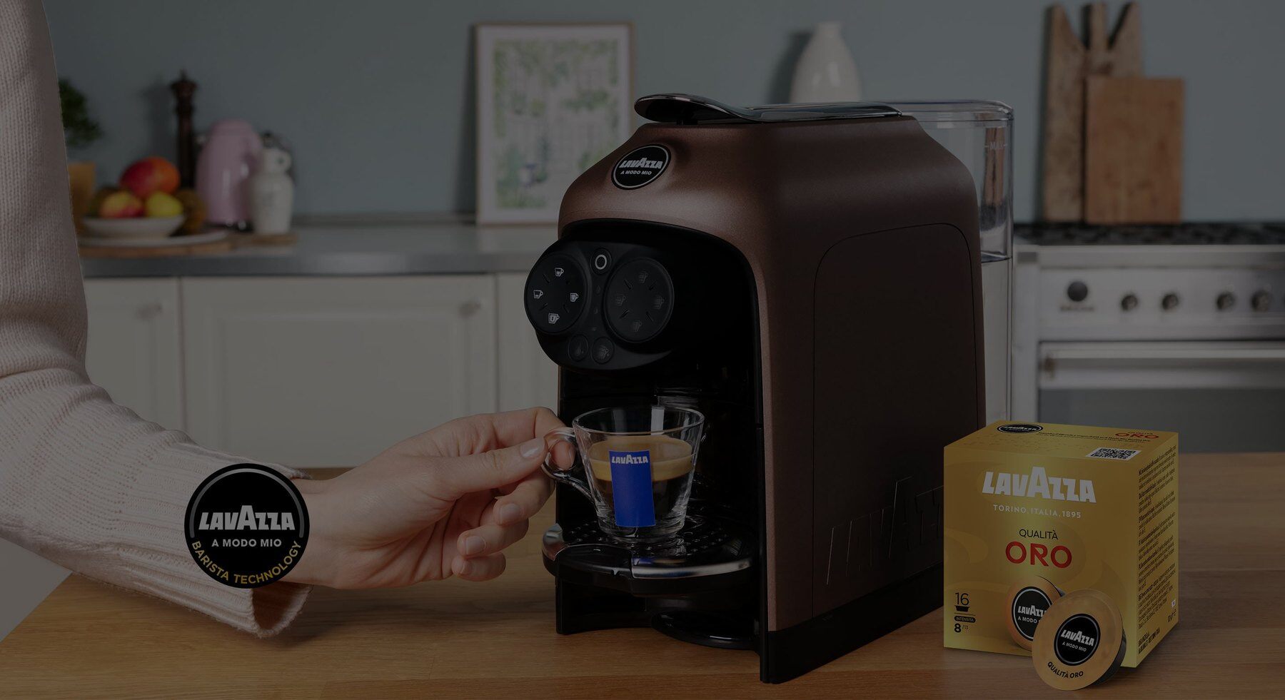 Lavazza A Modo Mio machine in a kitchen with an espresso and capsules