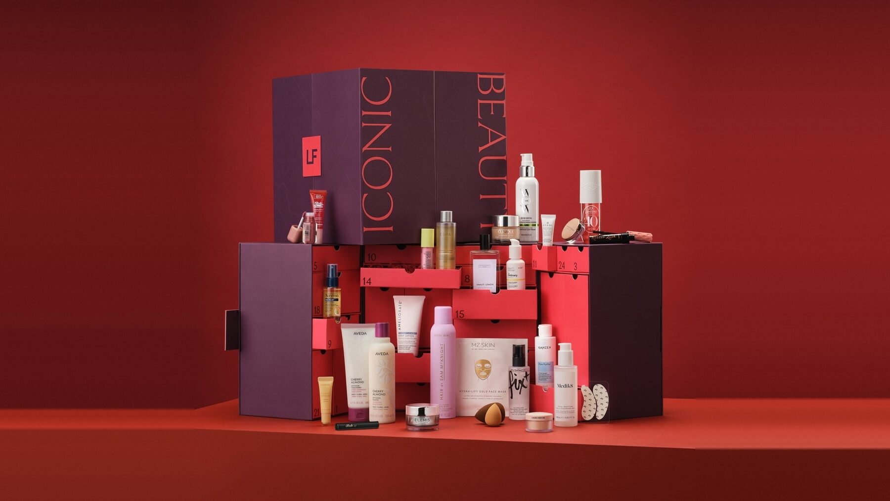 The LOOKFANTASTIC Beauty Advent Calendar open on a red set with its products displayed in front