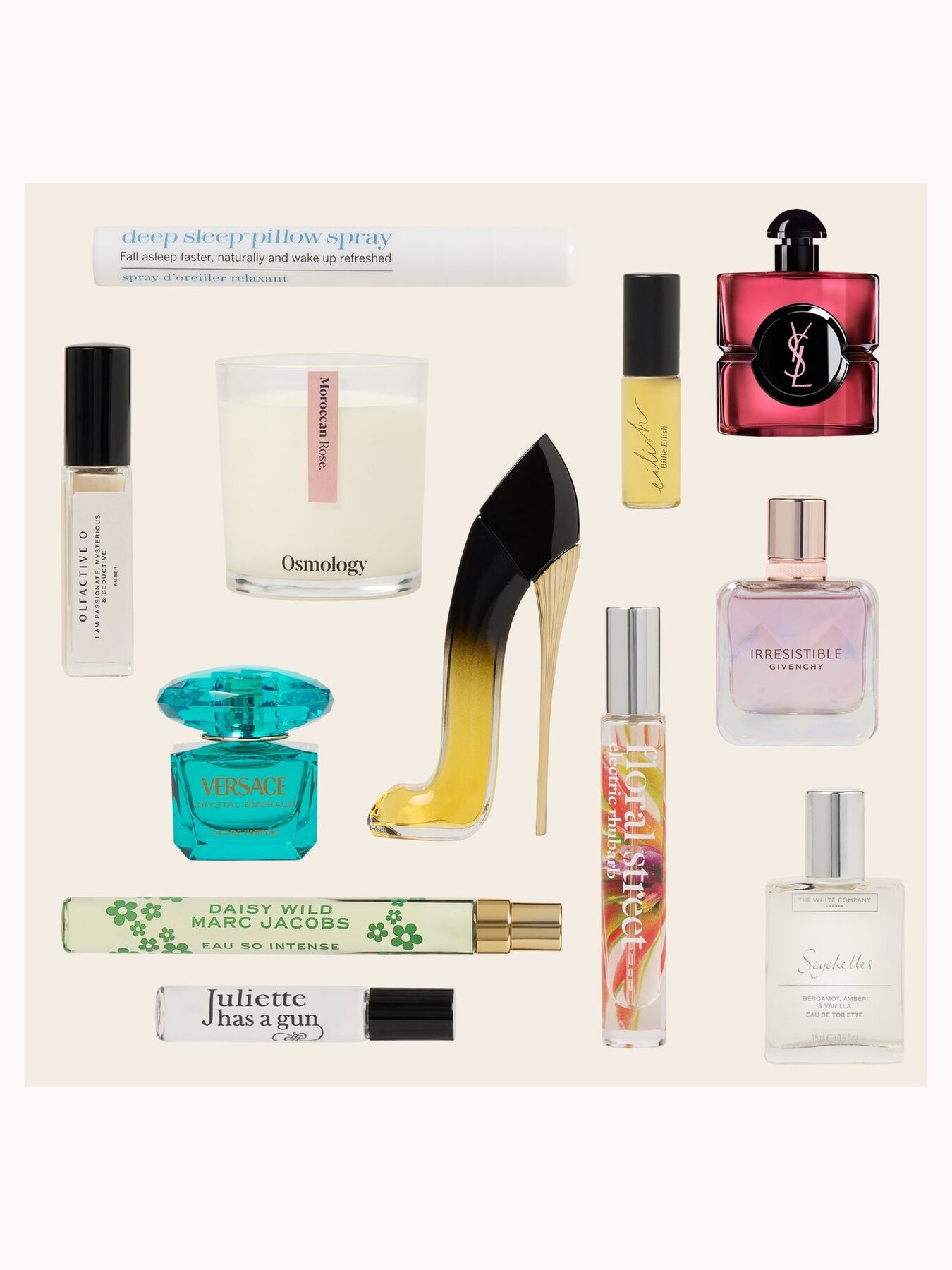 A flat lay of LOOKFANTASTIC Fragrance advent calendar products including a Carolina Herrera shoe bottle, a YSL Black Opium bottle, a Versace bottle and a candle