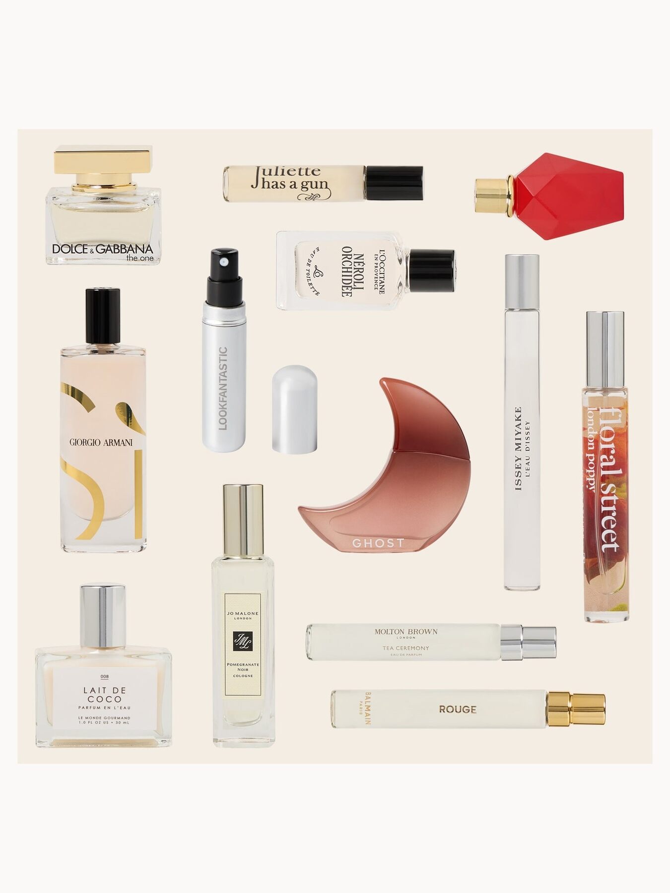 A second flat lay of LOOKFANTASTIC Fragrance advent calendar products including the Jo Malone Pomegranate Noir cologne, Floral Street sprays and a red Givenchy bottle