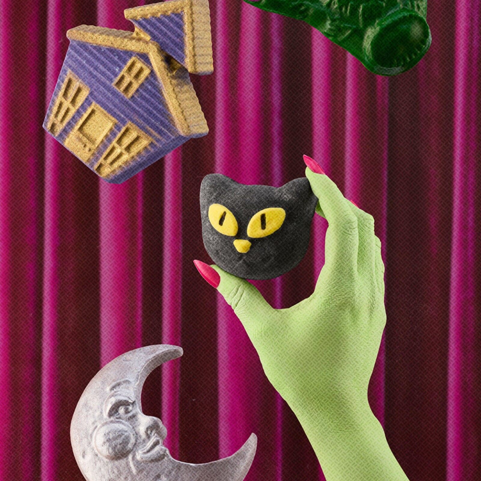 Lush Halloween products floating against a purple curtain, including a black cat bath bomb, a green hand and a crescent moon