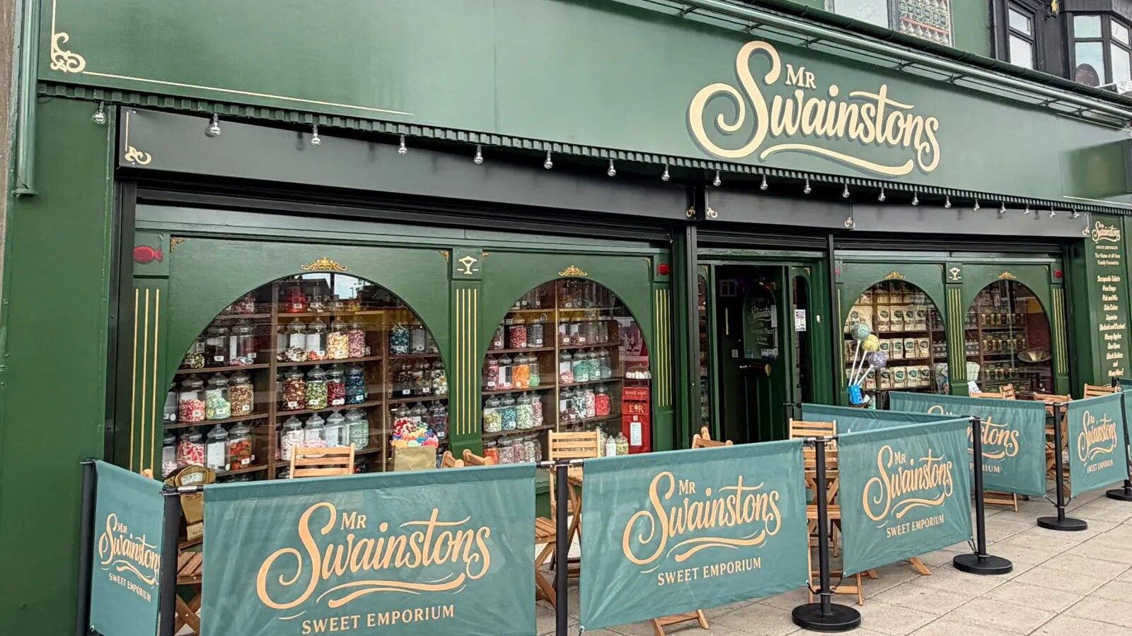 The green Mr Swainstons sweet shop frontage on Fowler Street in South Shields with jars in the arched windows