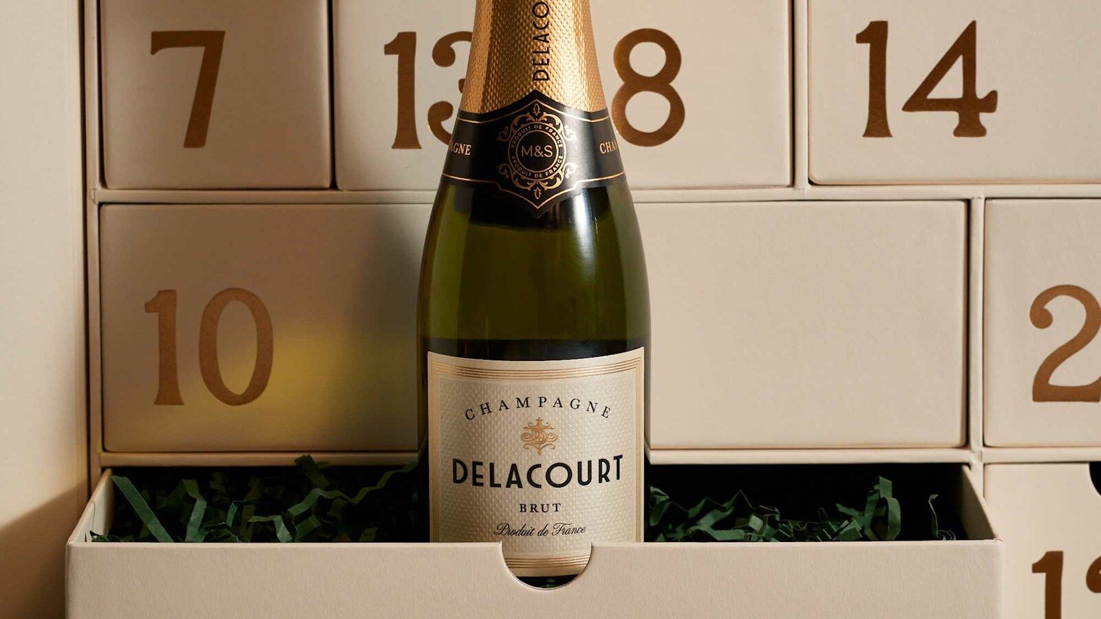 A bottle of Delacourt Brut champagne in an open drawer of the M&S Foodhall advent calendar