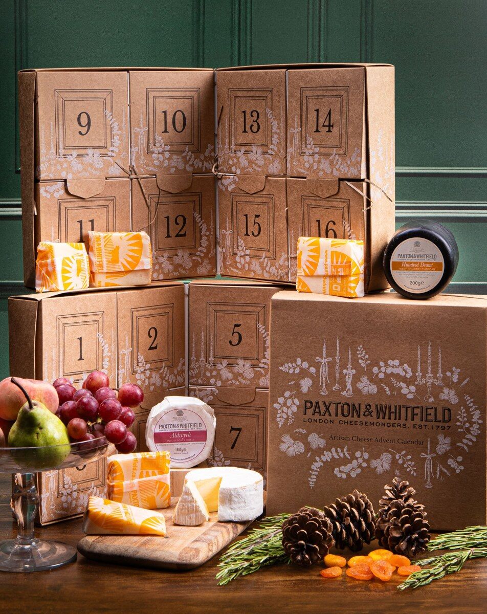 The Paxton and Whitfield cheese advent calendar 2026 with cheeses, grapes and crackers on a festive table
