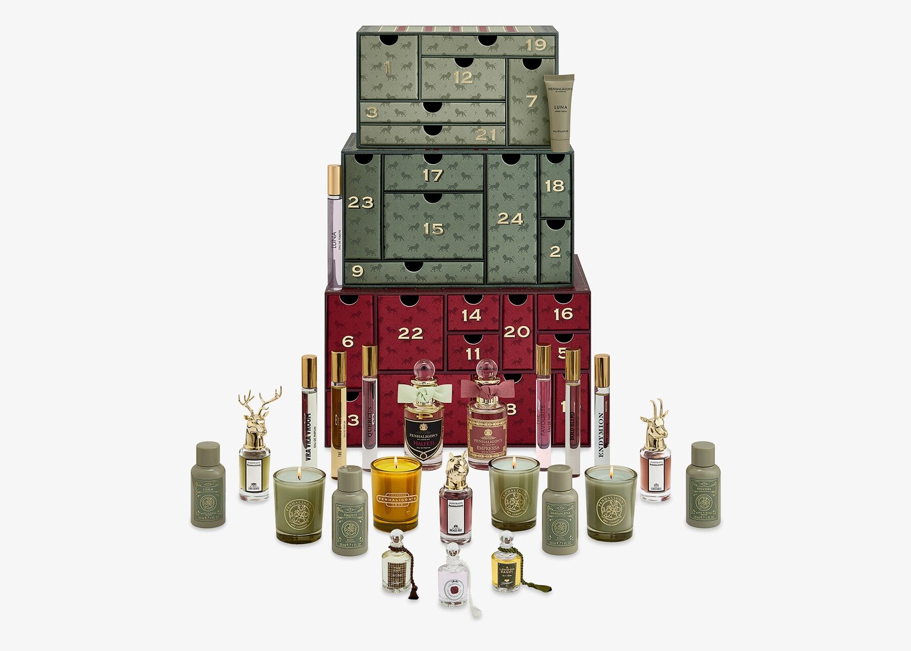The Penhaligon's advent calendar 2026, three stacked green and burgundy trunks with open numbered drawers, surrounded by perfumes, candles and body care