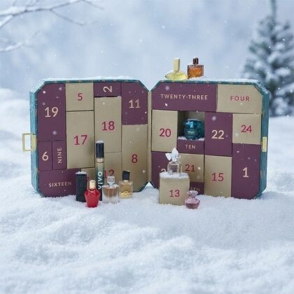 The Perfume Shop advent calendar 2026 open in the snow, with its numbered doors and a row of perfume miniatures in front