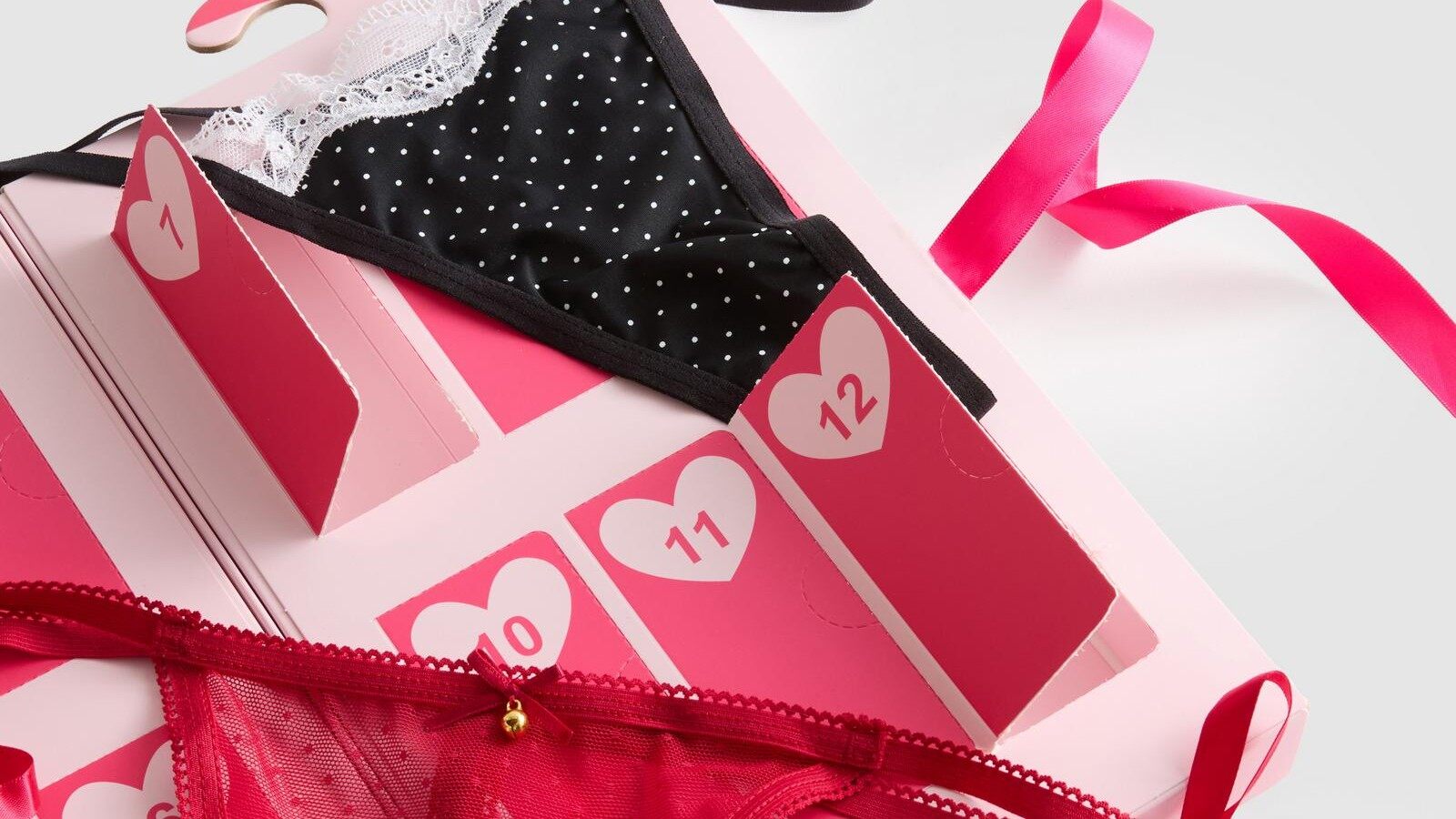The Primark 12 Thongs Of Christmas advent calendar open, showing the folded thongs in pink, red and patterned shades
