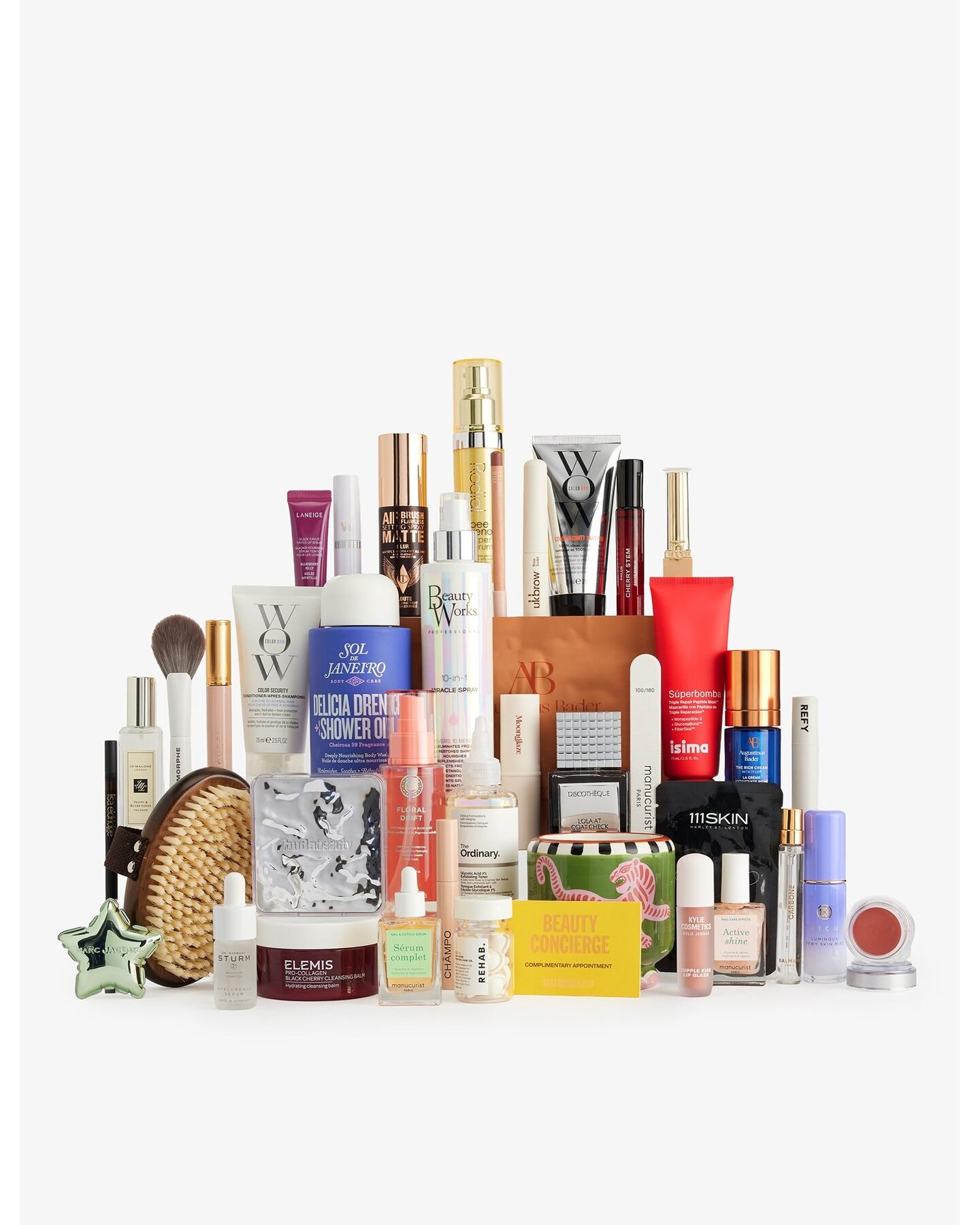The products of the Selfridges Beauty Advent Calendar 2026 stacked on a white background, with hair care, skincare, make-up and a candle