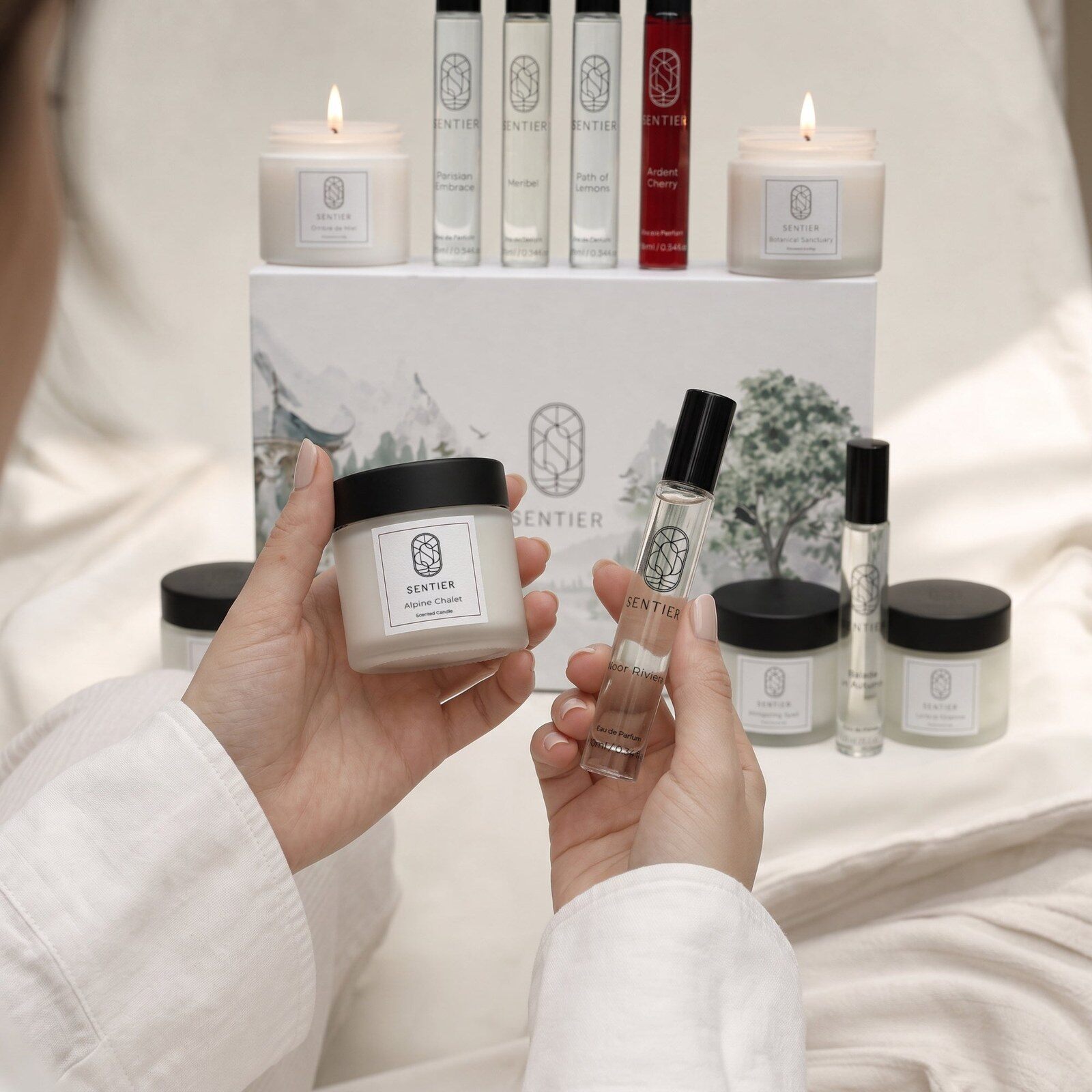 Hands holding a lit Sentier candle and a 10ml perfume bottle in front of the calendar