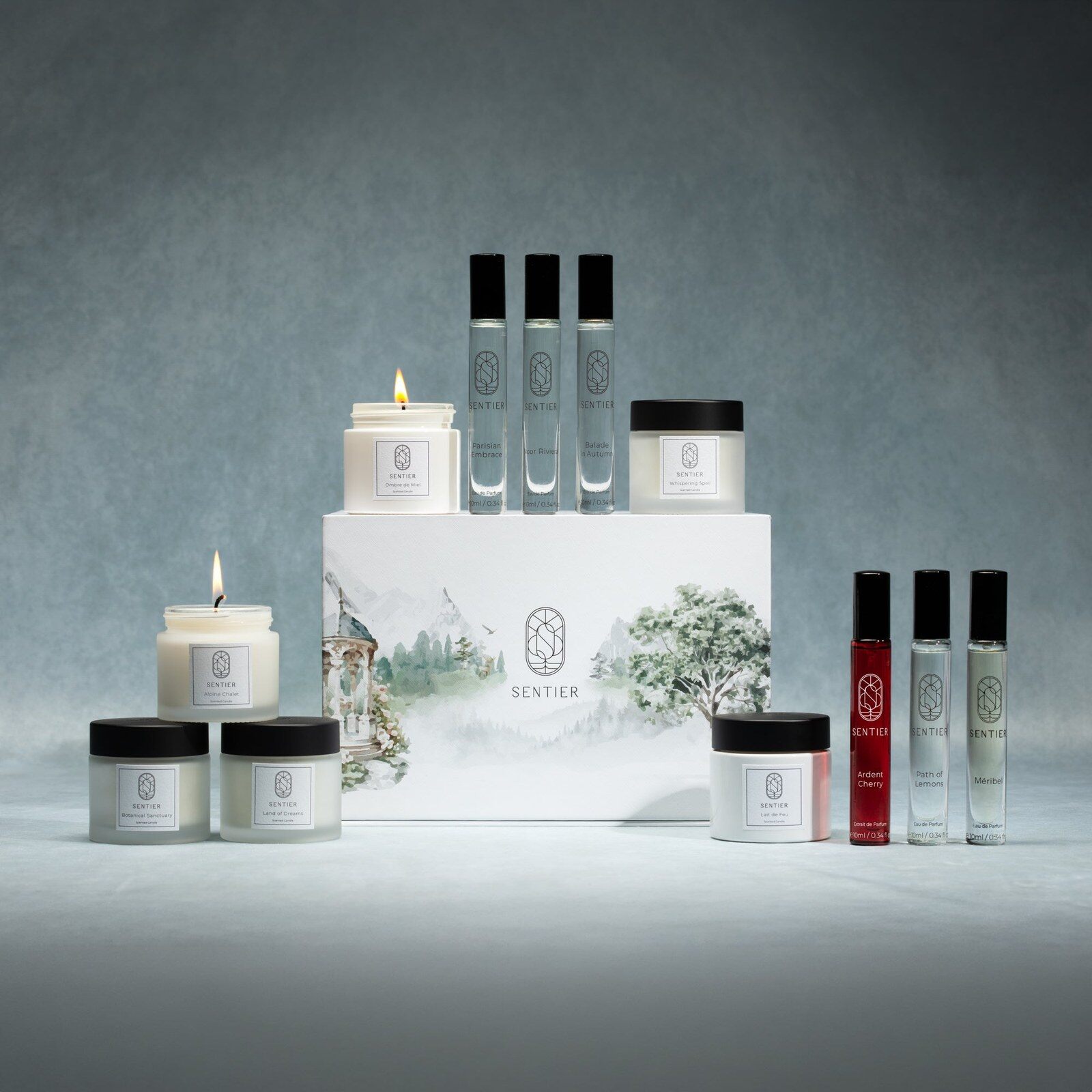 The Sentier Fragrance Advent Calendar 2026 box with its 10ml perfumes and 60g candles arranged around it