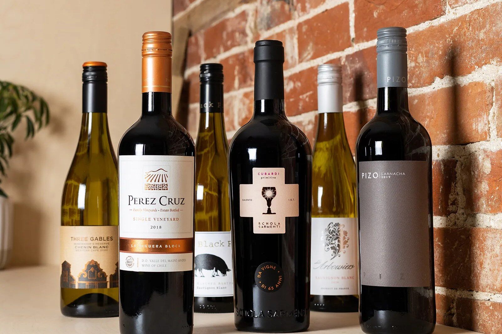 A selection of Virgin Wines red and white bottles on a kitchen counter