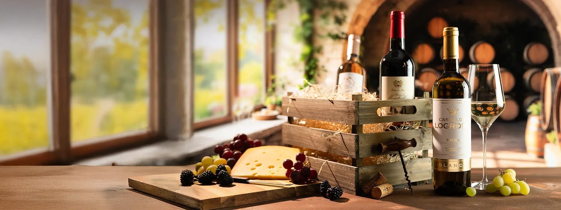 A Virgin Wines wooden case of bottles next to a cheese board