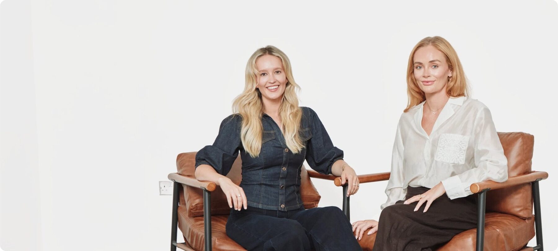 Holly Brooke and Joely Walker Sanderson seated side by side in a studio