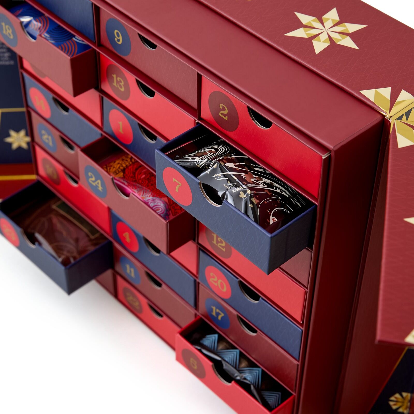 The Whittard Hot Chocolate Advent Calendar, a red box with gold stars and open drawers full of sachets