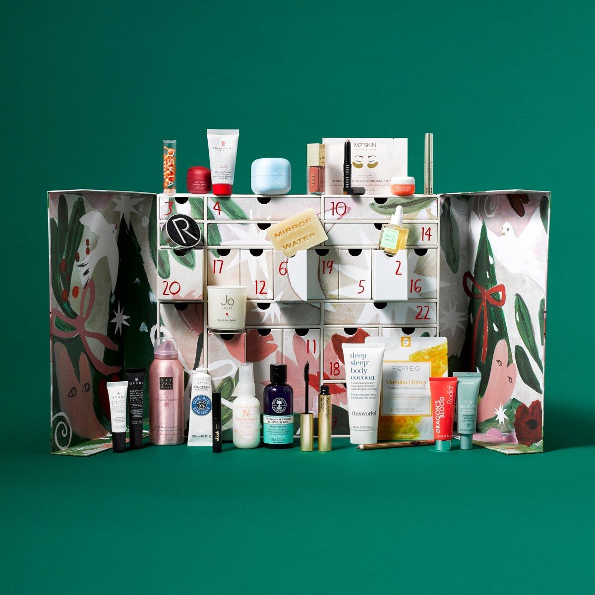 The open YOU Beauty advent calendar 2026 with its doors open and beauty products in front, on a green background